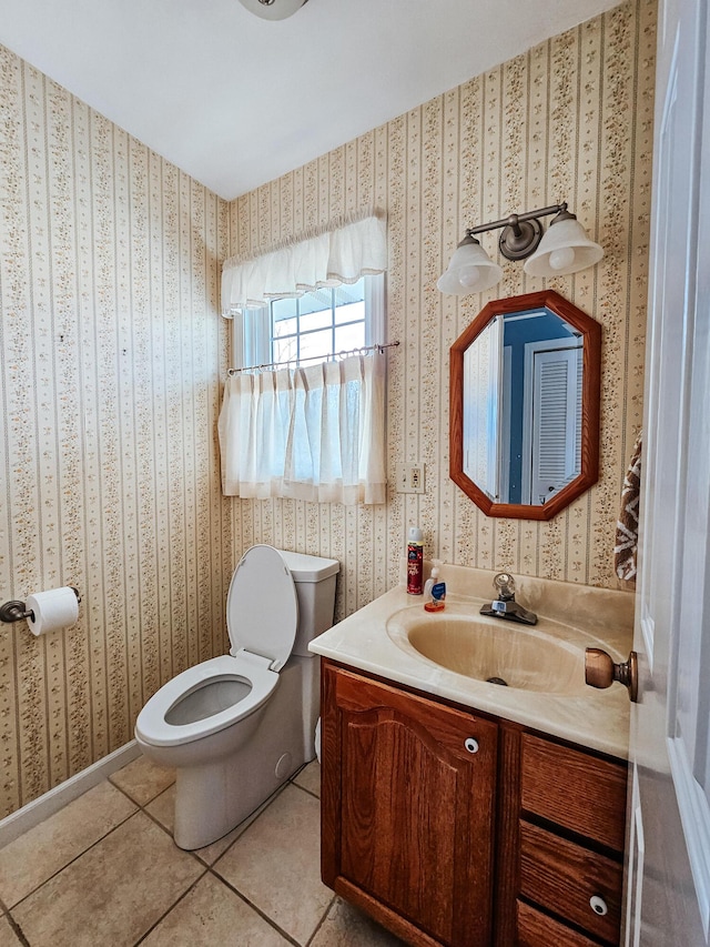 bathroom featuring tile patterned flooring, vanity, toilet, and wallpapered walls