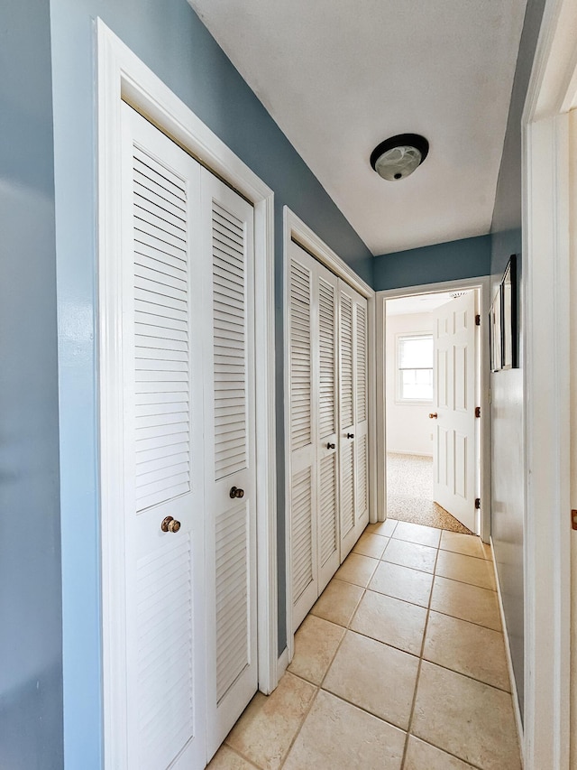 corridor with light tile patterned floors