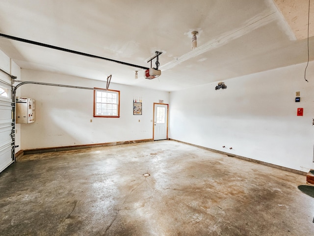 garage with baseboards and a garage door opener