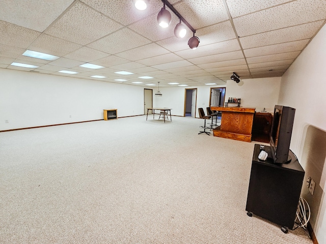 interior space with a dry bar, baseboards, a drop ceiling, and carpet flooring