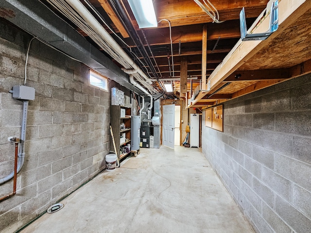 basement with water heater and concrete block wall