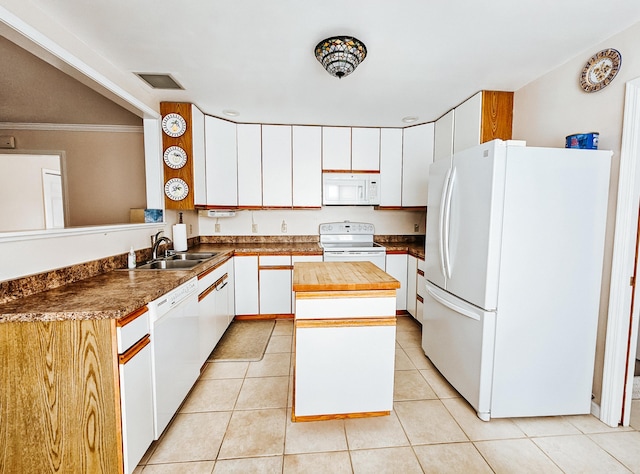 kitchen featuring white appliances, visible vents, butcher block counters, a center island, and light tile patterned flooring