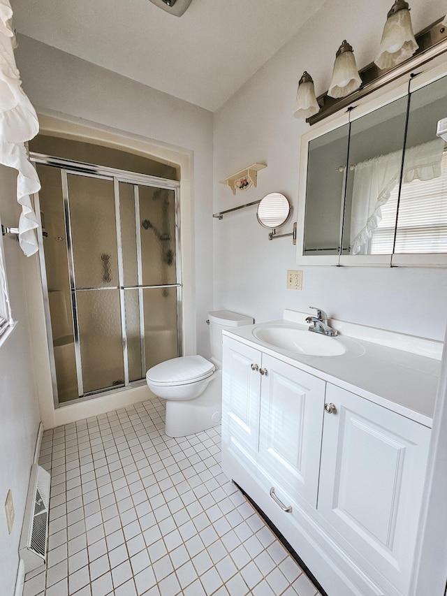 full bathroom featuring visible vents, toilet, a shower stall, vanity, and tile patterned floors