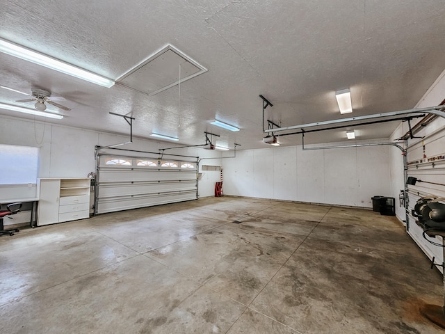 garage featuring ceiling fan and a garage door opener