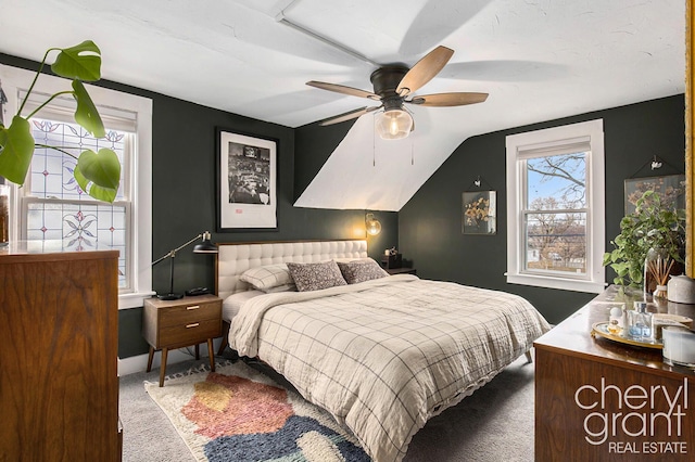 bedroom featuring carpet, baseboards, vaulted ceiling, and a ceiling fan