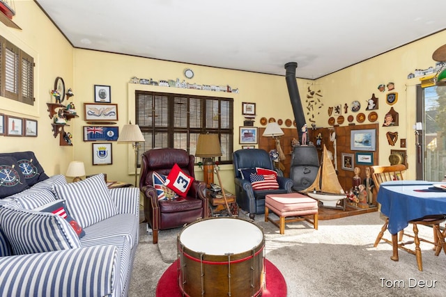 living room with carpet and a wood stove