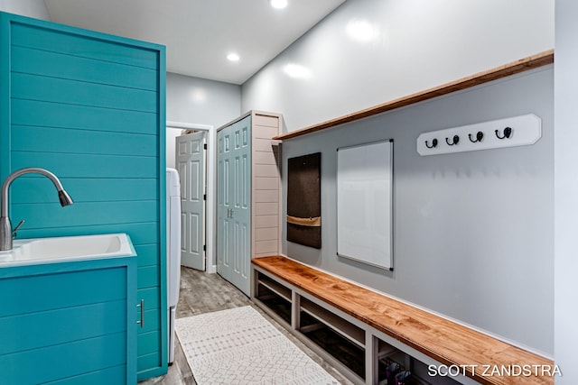 mudroom featuring wood finished floors, a sink, and recessed lighting