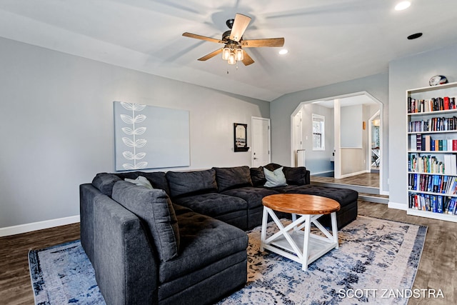 living area with arched walkways, recessed lighting, ceiling fan, wood finished floors, and baseboards