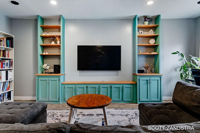 living area with light wood finished floors, baseboards, and recessed lighting