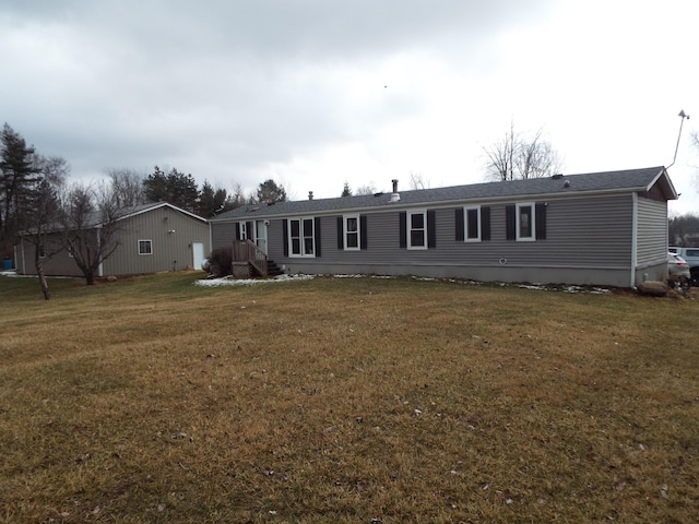 rear view of property with a lawn