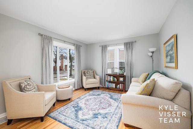 living room featuring wood finished floors and visible vents