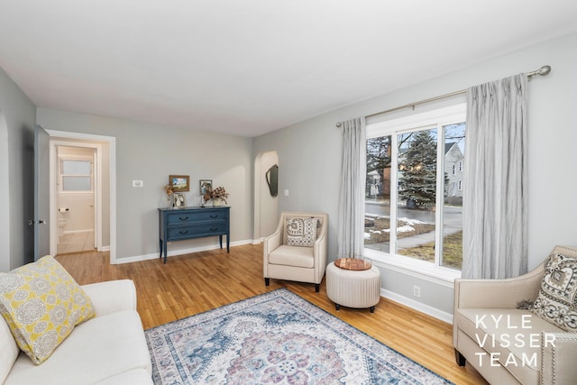 sitting room featuring baseboards and wood finished floors