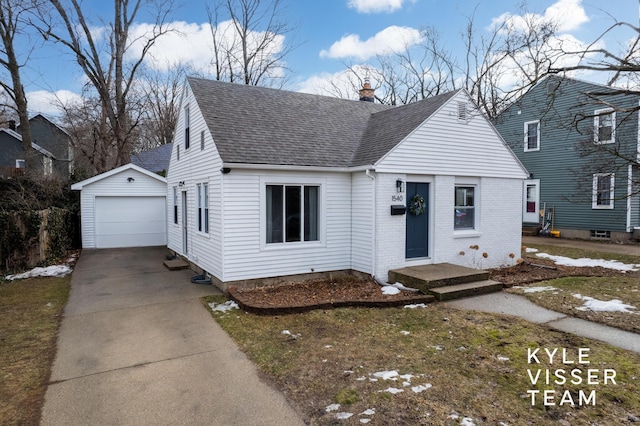 view of front of property featuring a garage, a chimney, roof with shingles, an outbuilding, and brick siding