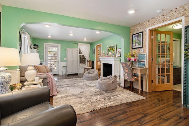 living room with dark wood finished floors, a fireplace, and recessed lighting