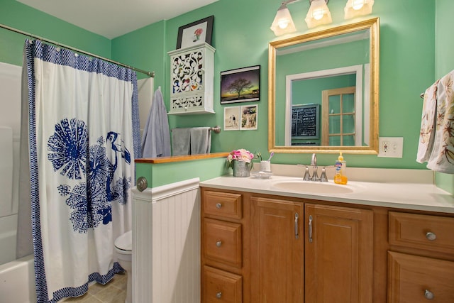 bathroom with shower / bathtub combination with curtain, vanity, toilet, and tile patterned floors