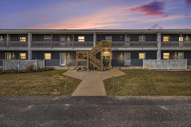 property at dusk with stairs