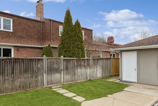 view of yard with a fenced backyard and an outdoor structure