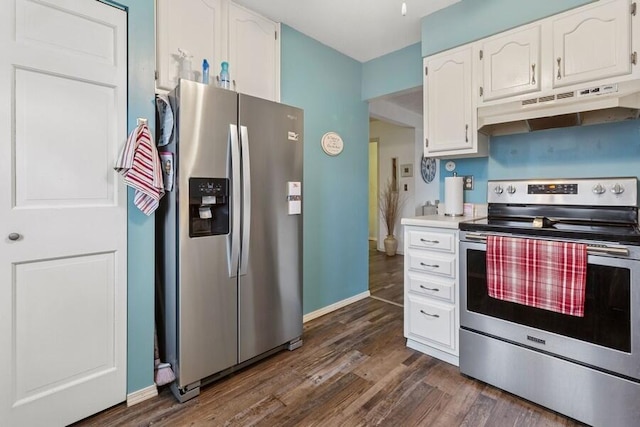 kitchen with dark wood-style floors, stainless steel appliances, light countertops, white cabinetry, and under cabinet range hood