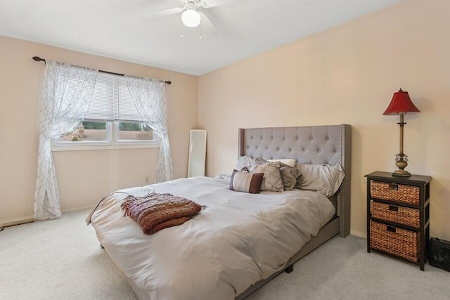 carpeted bedroom featuring a ceiling fan and baseboards