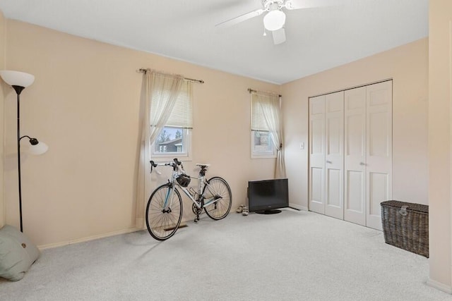 miscellaneous room with carpet, baseboards, and a ceiling fan