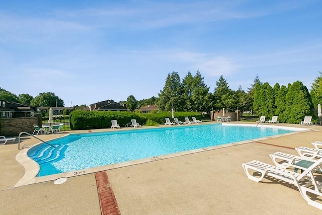 pool featuring a patio area and fence