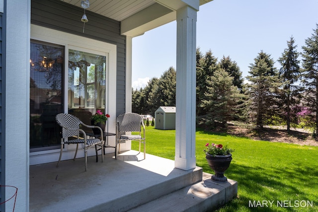 view of patio / terrace with a storage unit, an outbuilding, and a porch