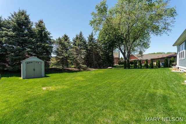 view of yard featuring a storage shed and an outbuilding