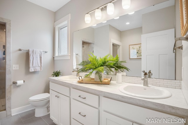 full bath with a shower stall, toilet, double vanity, and a sink