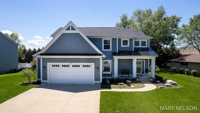 view of front of house with a front yard, a standing seam roof, concrete driveway, a garage, and metal roof