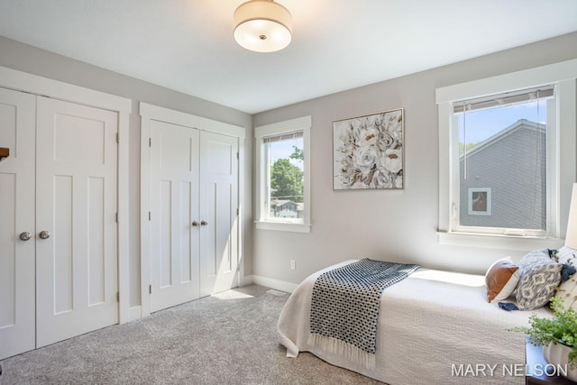 carpeted bedroom with baseboards