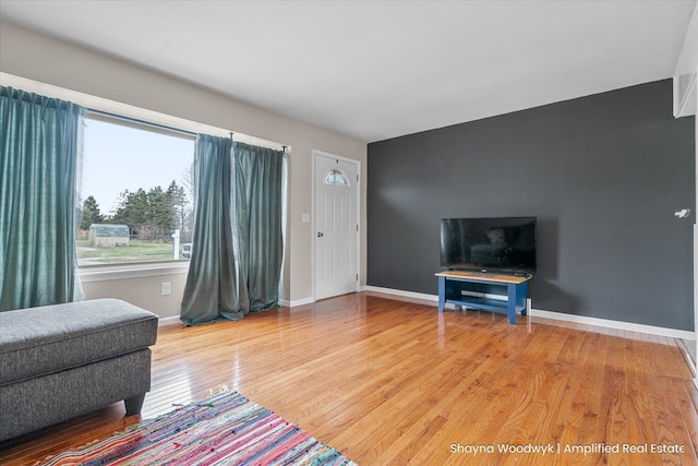 living room featuring light wood-style floors and baseboards