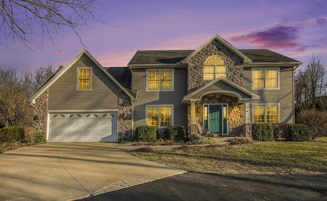 view of front of home featuring stone siding, concrete driveway, and an attached garage