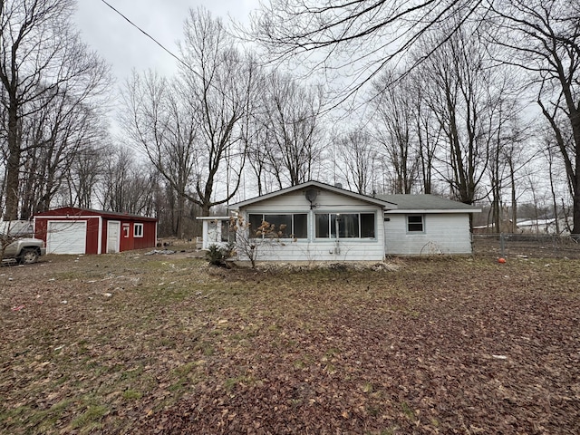 view of front of home with a garage and an outdoor structure