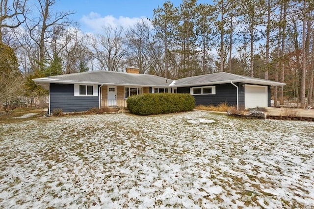 single story home with a chimney and an attached garage