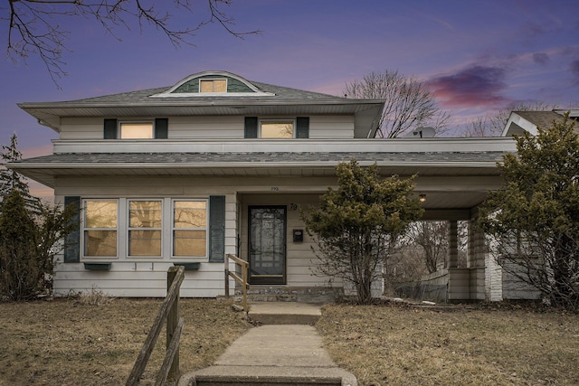 view of front of property with covered porch and roof with shingles