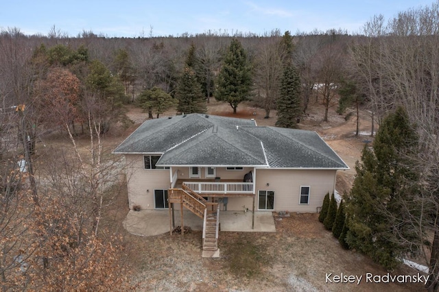 drone / aerial view with a wooded view