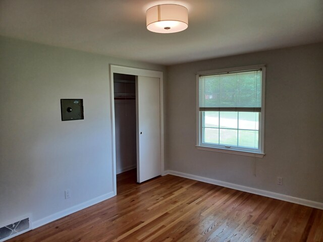 4265 Pine Tree Trl, Bloomfield Hills, MI 48302 - unfurnished bedroom with wood finished floors, visible vents, a closet, and baseboards