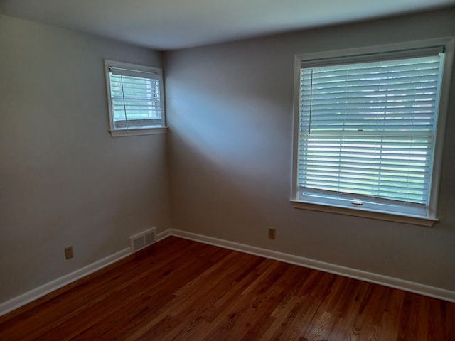 4265 Pine Tree Trl, Bloomfield Hills, MI 48302 - unfurnished room featuring visible vents, baseboards, and dark wood-style flooring