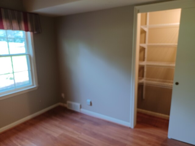 4265 Pine Tree Trl, Bloomfield Hills, MI 48302 - empty room featuring visible vents, baseboards, and wood finished floors