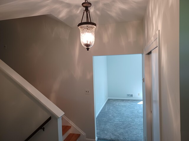 4265 Pine Tree Trl, Bloomfield Hills, MI 48302 - hall featuring stairway, carpet, visible vents, baseboards, and a notable chandelier