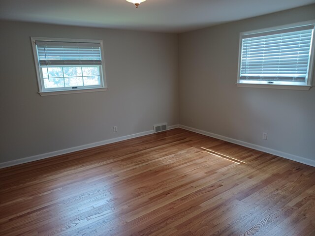 4265 Pine Tree Trl, Bloomfield Hills, MI 48302 - unfurnished room with visible vents, baseboards, and wood finished floors