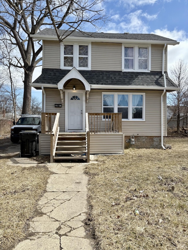 view of front of property featuring roof with shingles