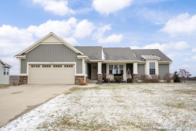 view of front facade featuring driveway, a shingled roof, an attached garage, covered porch, and board and batten siding