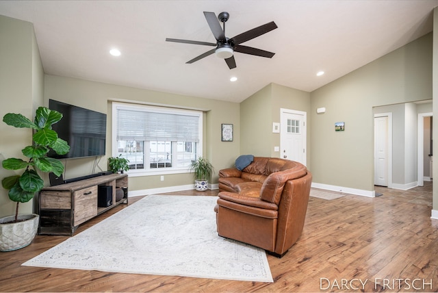 living area with vaulted ceiling, recessed lighting, wood finished floors, and baseboards