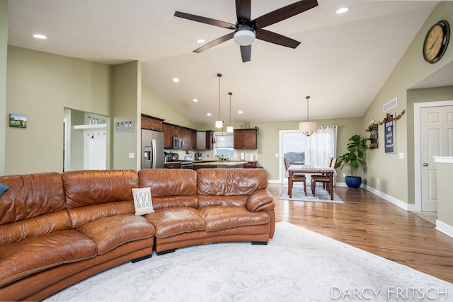 living room with light wood-style floors, baseboards, visible vents, and recessed lighting