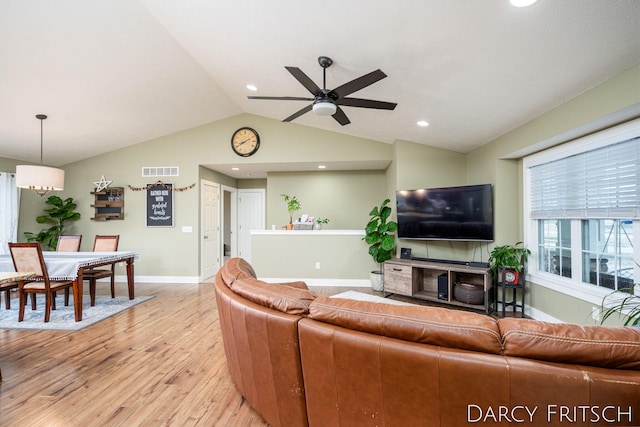 living area with baseboards, visible vents, lofted ceiling, light wood-type flooring, and recessed lighting