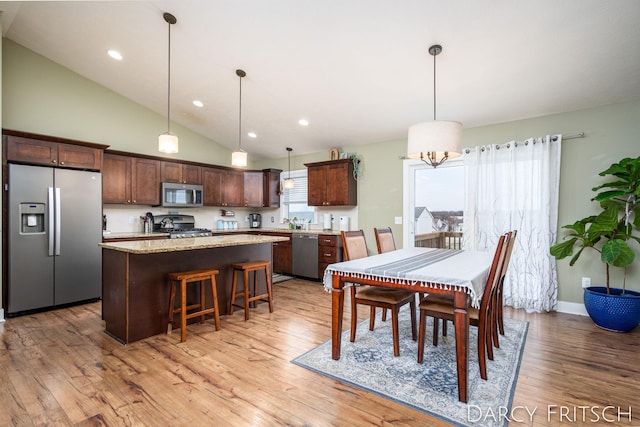 dining room featuring light wood-style floors, recessed lighting, high vaulted ceiling, and baseboards