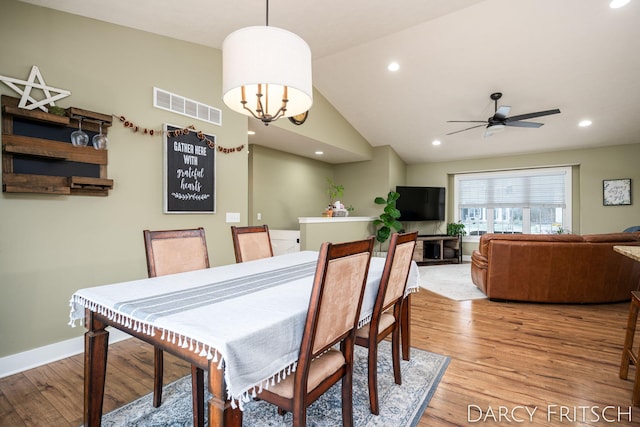 dining area featuring baseboards, visible vents, vaulted ceiling, light wood-type flooring, and recessed lighting