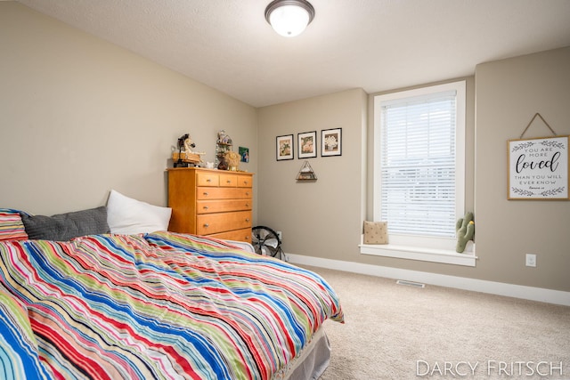 carpeted bedroom featuring visible vents and baseboards