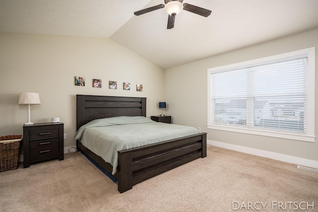 bedroom with lofted ceiling, light colored carpet, visible vents, a ceiling fan, and baseboards